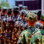 MIlitary Attack On Aid Convoy Sparks Humanitarian Alarm group of soldiers in Myanmar combat dress.