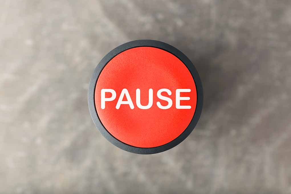 792571054 featured image Red button labeled PAUSE on gray background.