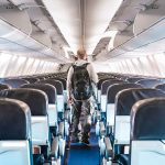 TERROR Risks Spike — U.S. Issues WARNING Person walking down empty airplane aisle