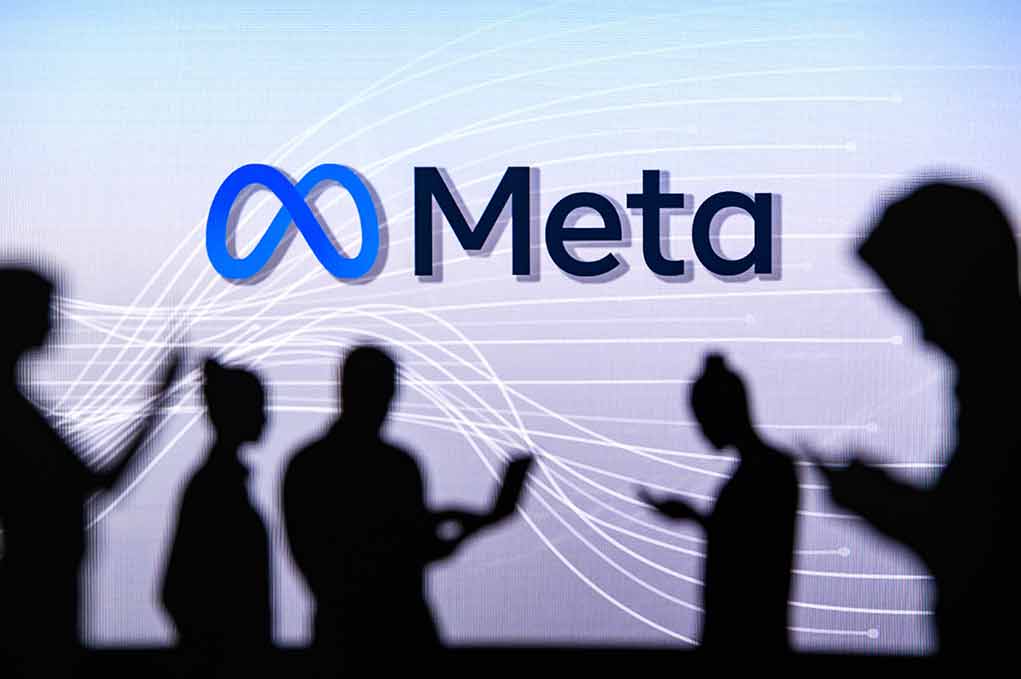 People silhouetted against Meta logo background