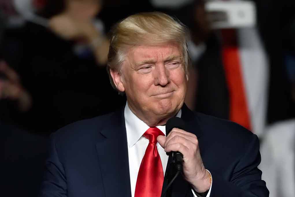 651225961 featured image Man in suit holding a microphone indoors