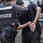 Top Reporter Arrested in Shocking Vandalism Spree Police officer arrests handcuffed person