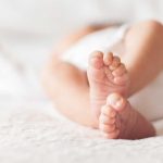 Close up of baby feet lying on blanket