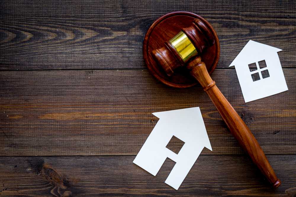 1126501304 featured image Gavel and house cutouts on wooden table