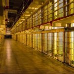 PhD Student Earns LIFE SENTENCE – HEINOUS! Empty hallway between rows of prison cells