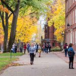 People walking on a college campus in autumn