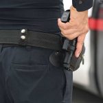 Cop Killer Charged — Courtroom ERUPTS Person holding a gun in a holster