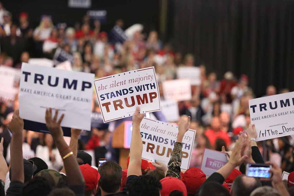 427399264 featured image Crowd holding signs supporting Trump at a rally