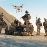 Border Breach EXPOSED — Drone Invasion Sparks Fear Soldiers operating a drone in a desert environment