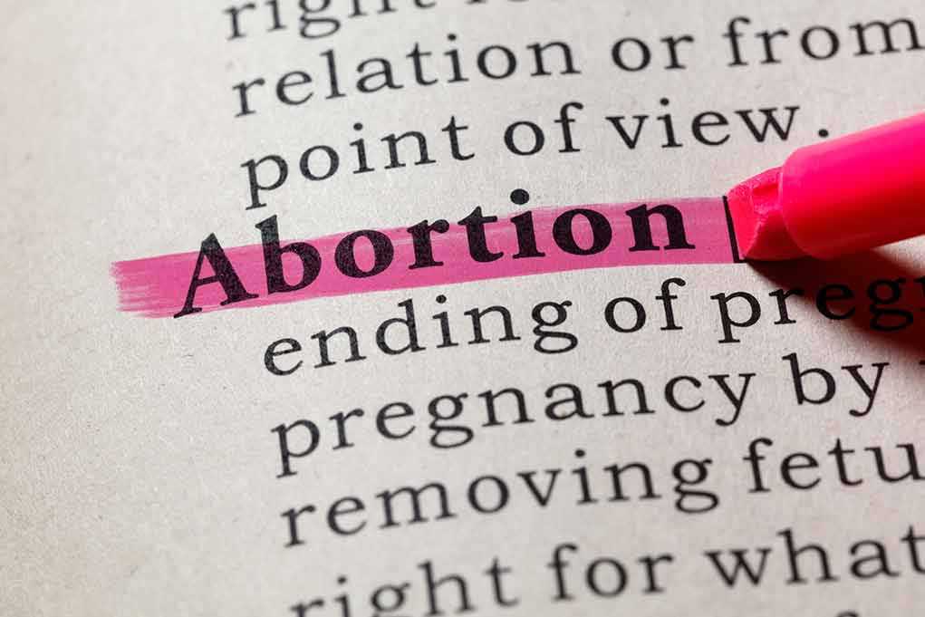 1140499358 featured image Abortion highlighted in a dictionary with a pink marker