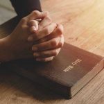 Bible Twist Sparks Border SHOWDOWN Hands praying on a Bible
