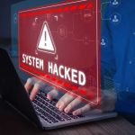 ZuRu Strikes Apple Users—SECURITY Chaos Explodes Warning sign "System Hacked" on laptop screen.
