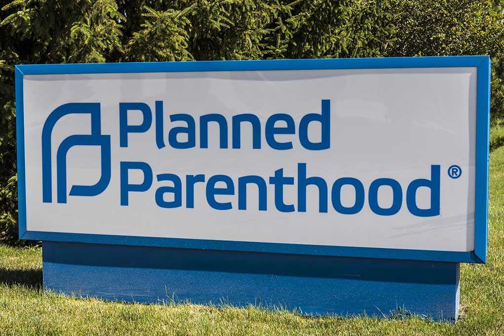670284427 Planned Parenthood sign on a grassy lawn