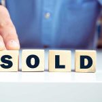 Housing Market SHIFT: Buyers Now Control Blocks spelling SOLD with a hand touching them.