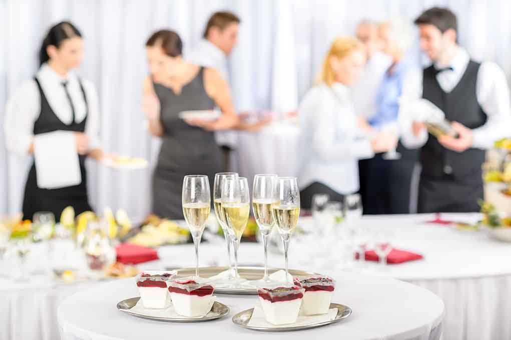 A table set with champagne glasses and desserts at a social event