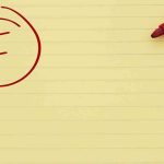 Yellow notepad with a red marker and a circled grade F