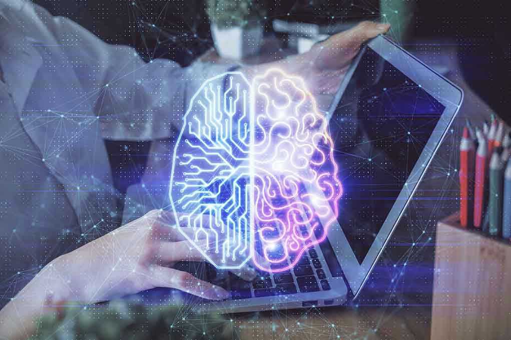 2048543435 Futuristic AI brain hologram above a laptop computer.