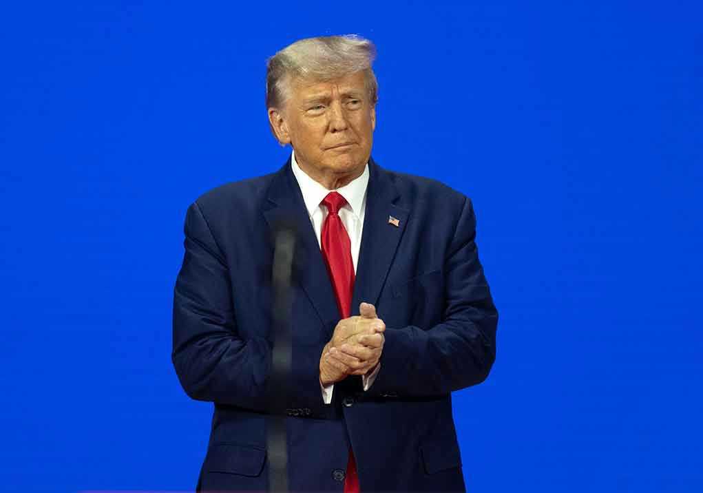 Man in a suit with a blue background.