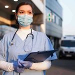 Nightmare Unleashed: Nurse KIDNAPS Immigrants! Nurse in scrubs and mask outside hospital holding clipboard.