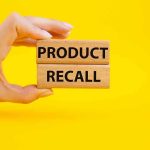 NATIONWIDE Recall Announcement—Millions Impacted Instantly Hand holding Product Recall blocks on yellow background.