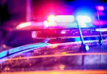 Police car lights flashing at night.