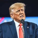 Trump REVIVES Project – Green Lobby Melts Down! Man in suit speaking at a microphone.