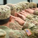 Troops SENT HOME – Weight Standards Crackdown Soldiers in uniform saluting, American flag patch visible.