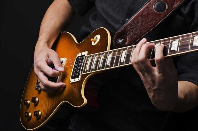 92514370 Hands playing an electric guitar.