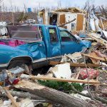 MONSTER Tornado WRECKS Mid-West: Mother Nature Unleashed! A blue truck surrounded by debris and destruction from a natural disaster