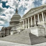 Russians Dump Files – Cue Washington MELTDOWN! The U.S. Capitol building with a cloudy sky backdrop