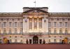 Royal Bloodline SHATTERED—Prince Banished Forever Front view of Buckingham Palace with illuminated facade and British flag