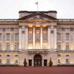 Royal Bloodline SHATTERED—Prince Banished Forever Front view of Buckingham Palace with illuminated facade and British flag