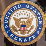 Self Declared Communist Rocks Senate Race – He Confessed! Sign displaying United States Senate in a government building