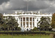 $50 Million Bounty Blitz – White House Posts Reward The White House with overcast sky and flag raised.