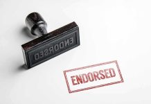 Rubber stamp with ENDORSED text on paper.