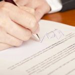 Autopen Scandal Rocks Trump Pardons – Biden 2.0? Hand signing a document with a pen.