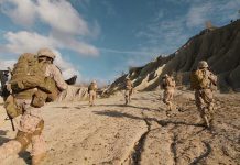20 Soldiers VANISH — No Distress, No Answers Soldiers running on rocky terrain with backpacks.