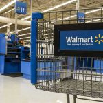 Walmart shopping cart inside store near checkout aisle