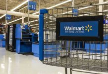 AI Shockwave Hits Walmart—1.6 Million Jobs at Risk Walmart shopping cart inside store near checkout aisle