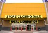 Exterior of a store with a large sign announcing a closing sale and total liquidation