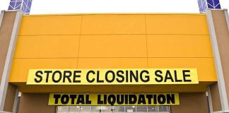 Exterior of a store with a large sign announcing a closing sale and total liquidation