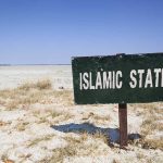 Governor Candidate Issues EXTRAORDINARY Pledge—Why This Changes Everything A weathered sign reading 'ISLAMIC STATE' in a barren landscape