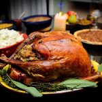 Surprising Benefits of Your Favorite Thanksgiving Staples A beautifully roasted turkey on a festive table surrounded by side dishes and decorations