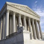 Supreme Court Takes Case: Trump’s FTC Target In Sight Supreme Court building with statue and columns.