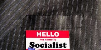 Hello my name is Socialist name tag on suit.