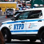 Mamdani Makes WORST Pick Yet – “People Will Die” NYPD police car on a city street scene.