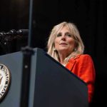 Person speaking at podium with Vice President seal.