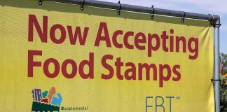 Yellow sign now accepting food stamps EBT SNAP