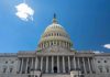 Congressional Hearing ERUPTS – Protestors RUSH IN! U.S. Capitol building against a clear blue sky.