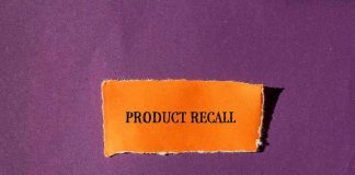 Product Recall text on orange paper, purple background.